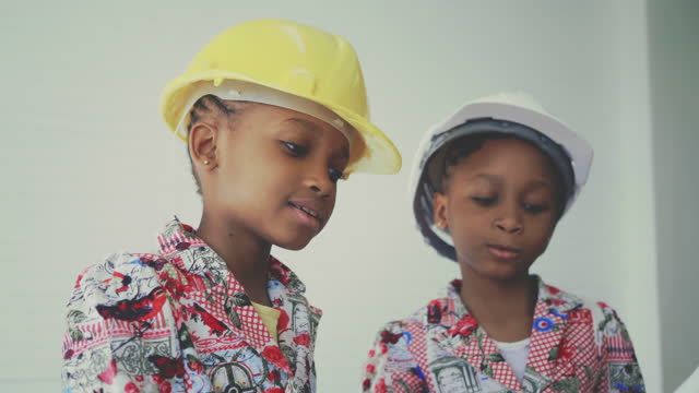 African twin girls pretending to be a engineer