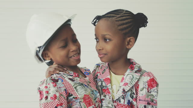 African twin girls pretending to be a engineer
