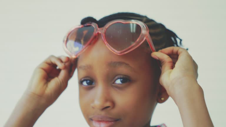 Girl wearing sunglasses against white background