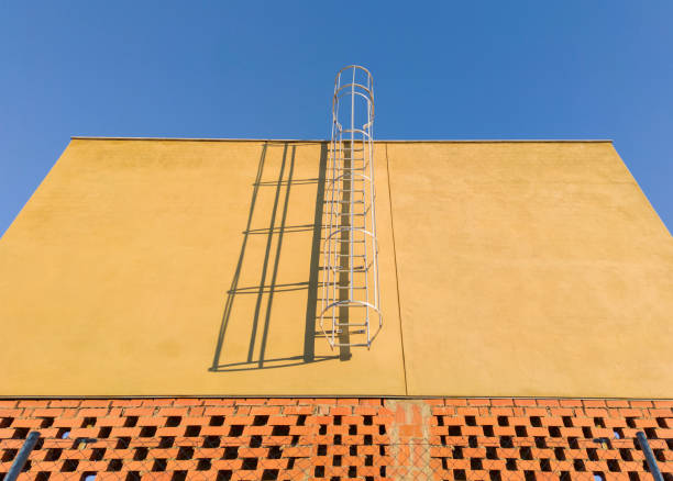 Service ladder installed on a commercial premises under construction. Blue sky background