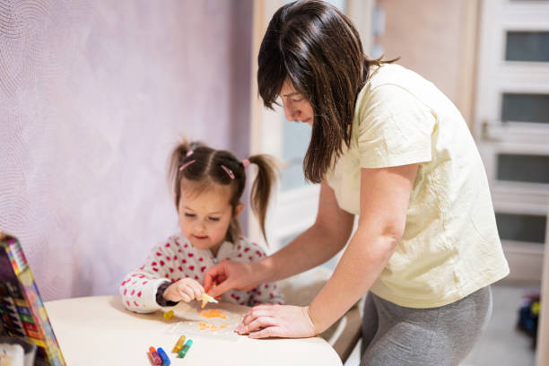 istock Mother and daughter decorating art with glitter decor. 1471823849