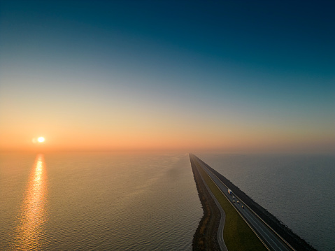 Drone panorama photography of an dyke called Houtrib dijk in Lake Markermeer in the province Flevoland. The highway dyke N302 from Lelystad to Enkhuizen. At sunrise.