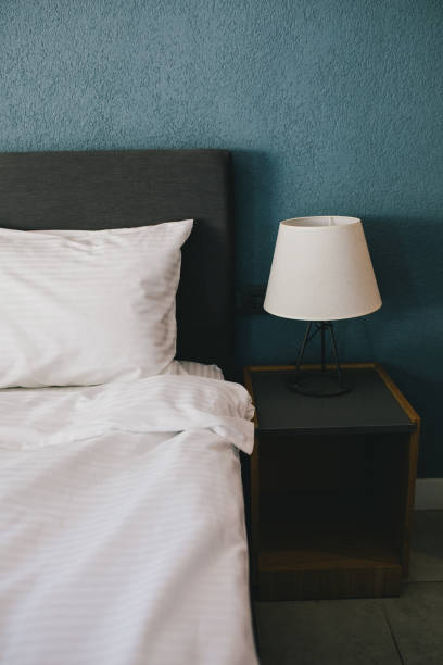 istock Bed and white linens in a hotel room. 1471827662
