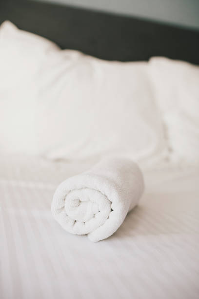 istock Bed and white linens in a hotel room. 1471827677
