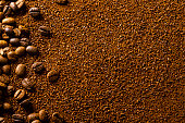 Grounded coffee beans background with copy space