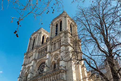 The facade is 41 metres wide and includes four powerful buttresses and three portals. The West Facade of Notre-Dame cathedral took less than a century to be built. Construction started in 1200 under the direction of Paris' bishop Eudes de Sully.