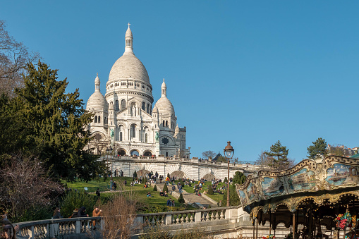 The Sacré-Coeur, consecrated in 1919, is one of the most iconic monuments in Paris. At the top of the Butte Montmarte, it has one of the most beautiful panoramic views of the capital, from 130 metres above ground. In a Roman-Byzantine style, the Sacré Coeur is recognizable by its white colour. Inside the building, the ceiling is decorated with the largest mosaic in France measuring about 480 m².