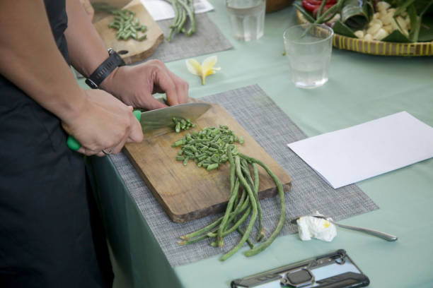istock Adult students learning recipe and preparing meal in cooking class 1471832689