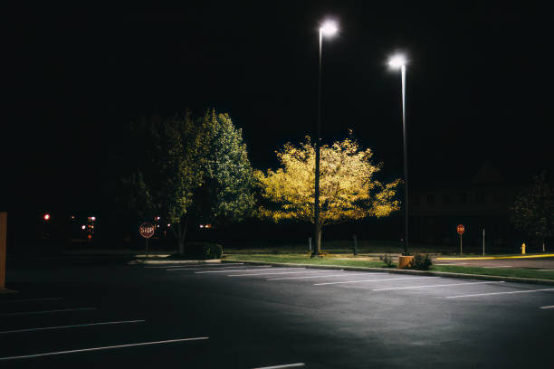 istock Empty parking lot lit by street lights. 1471833327