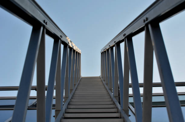 aluminium-fußgängerbrücke zum waschen von fenstern über dem oberlicht. vereinfacht das waschen von großen gewächshäusern und galerien mit deckenfenstern. die leiter kann über die schienen bewegt werden, blauer himmel, kelle - architecture roof aluminum sheet industry stock-fotos und bilder