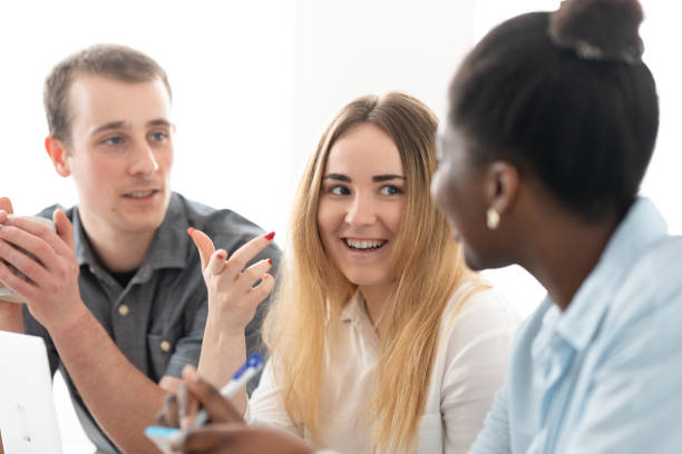 istock Blonde freelancer talking with coworkers 1471838270
