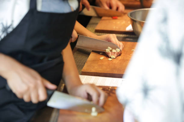 istock Adult students learning recipe and preparing meal in cooking class 1471839362