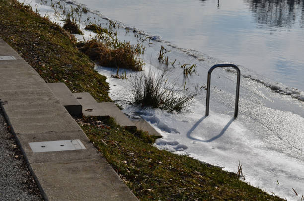 istock frozen river has modified entrances to water from  embankment. swimmer decides to take a bath as part of conditioning and hardening after sauna, it is possible to use stainless steel steps, ladder 1471839381