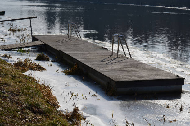 istock frozen river has modified entrances to water from  embankment. swimmer decides to take a bath as part of conditioning and hardening after sauna, it is possible to use stainless steel steps, ladder 1471839523