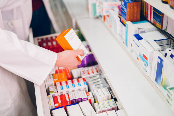 istock The pharmacist arranges the medicines in the pharmacy 1471840123