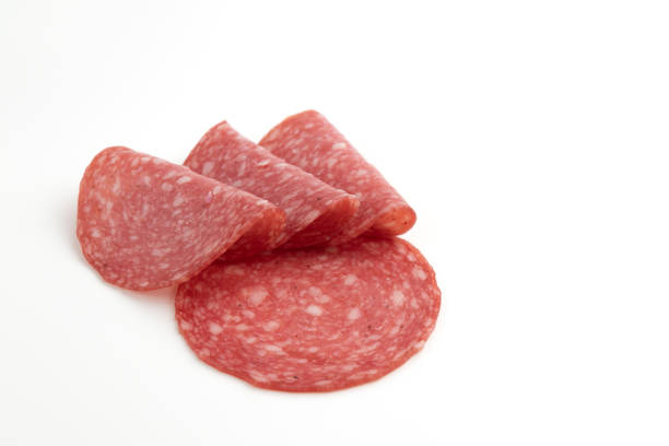 istock salami sausage cut into pieces isolated on white 1471841324