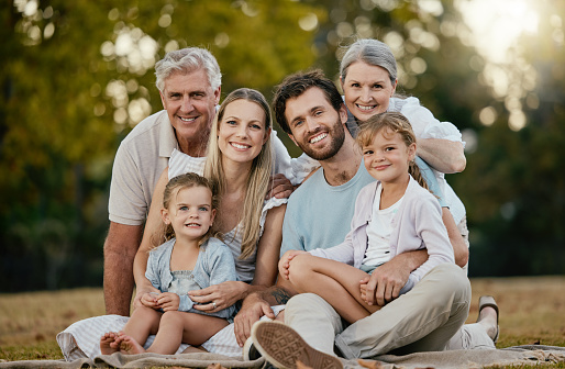 Family picnic, park portrait and smile with kids, parents or grandparents for bonding together, love or relax. Happy family, nature and generation care with children, mom and dad in summer sunshine