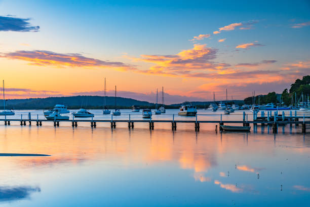 istock Sunrise waterscape with boats and clouds 1471842470