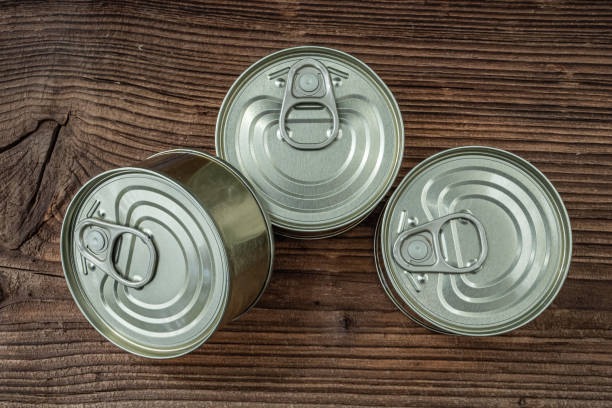 istock Tin cans with food on dark rustic wooden background. 1471842520