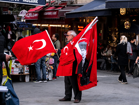 January 10, 2023 Istanbul, Kadikoy - An old man sells Turkish flags.