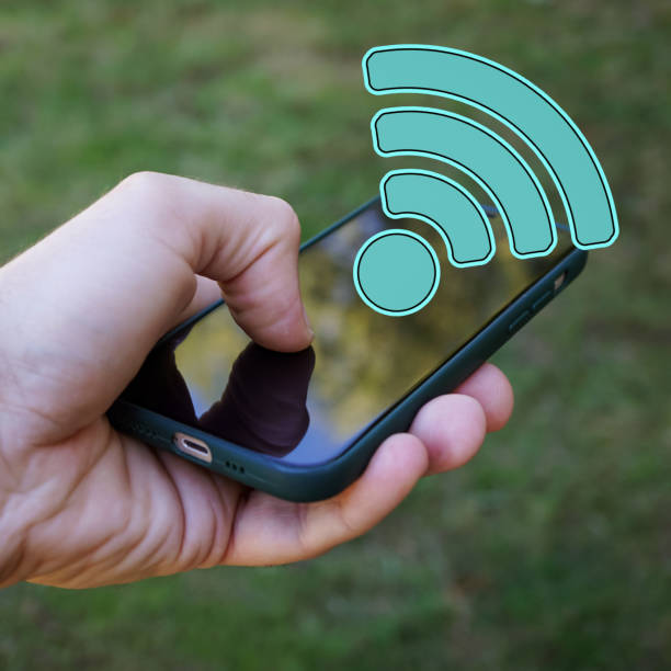 istock hand holding a smart phone with wifi icon, Wireless Fidelity 1471847228