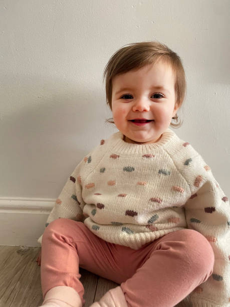 One year old girl in wool sweater stock photo