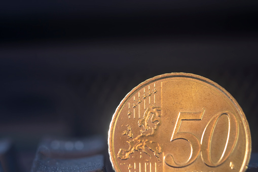 Macro of a 50 euro cent coin with copy space for text. A euro coin on a dark background. Fifty cent.