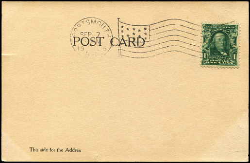 UK Letter with 1st class stamp, with copyspace for address, isolated on black.