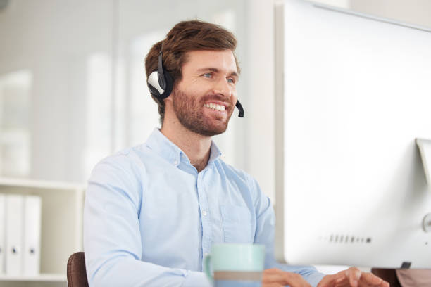 istock Call center, computer and businessman with smile for virtual support, communication and software help in information technology office. Happy corporate worker with technology for telemarketing sales 1471850938