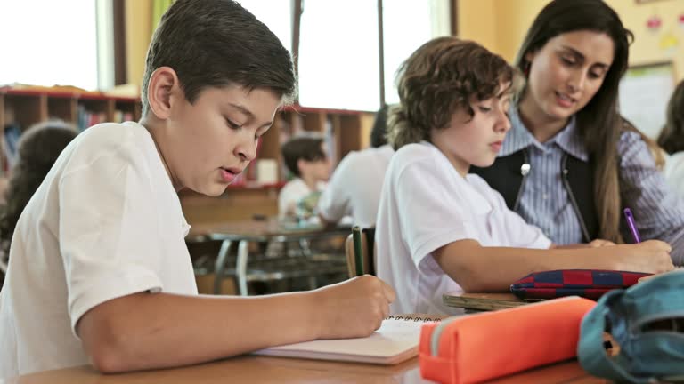 Hispanic school children and educators in classroom
