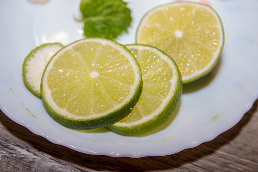 Close up of lemons and green limes isolated over white