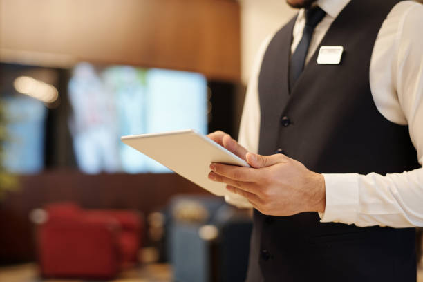 istock Close-up of young male receptionist using tablet during work 1471856563