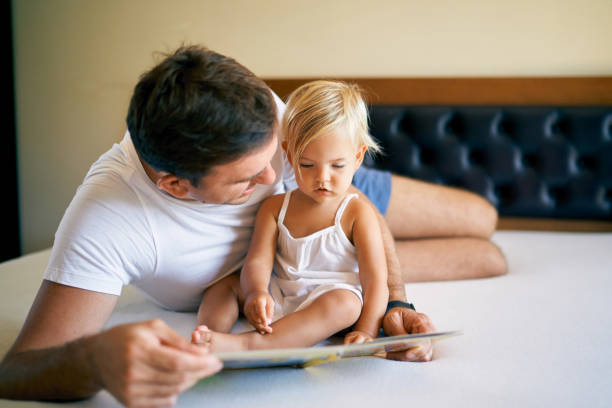 istock Dad teaching little daughter to read 1471857060