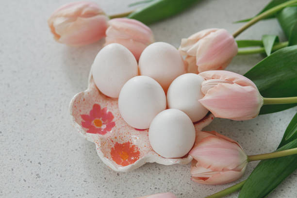 istock Beautiful tulips and natural eggs on modern table. Stylish easter still life with copy space. Happy Easter! Handmade egg holder with pink tulips 1471857092