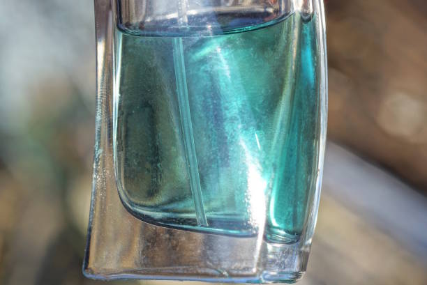 istock one white glass bottle with green cologne liquid 1471858688