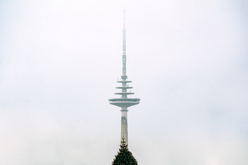 Scenic view of a radio tower against the evening lightly overcast sky
