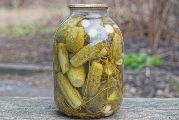 istock one large glass jar with green canned cucumbers 1471859043