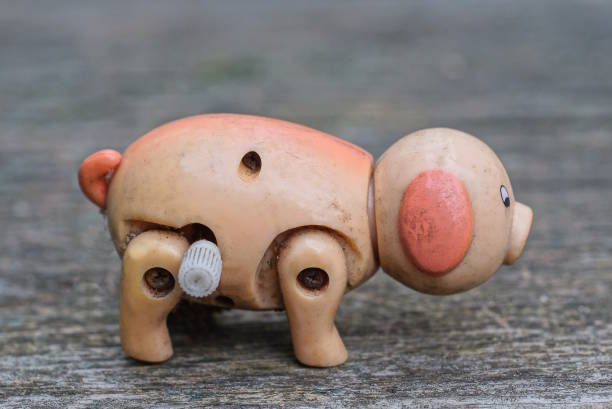 istock one old dirty plastic mechanical brown toy pig 1471859046