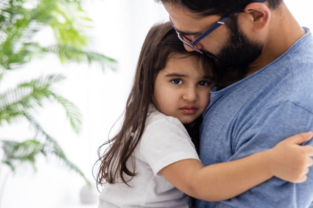 istock Separation Anxiety - Father Holding Little Daughter 1471859868