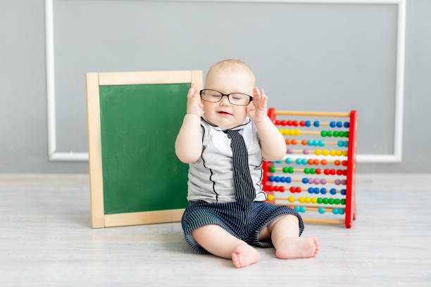 istock baby in glasses with scores and chalk board with space for text, school and learning concept 1471860014