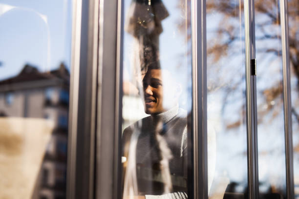 istock Friends in a restaurant smiling and having a conversation. View from outside with window reflections.. 1471861978