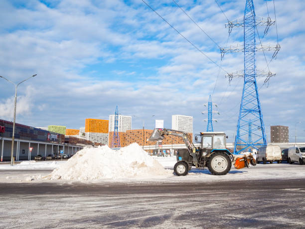 tractor bielorrusia con una pala vierte nieve en una gran pila - snowplow snow parking lot truck fotografías e imágenes de stock