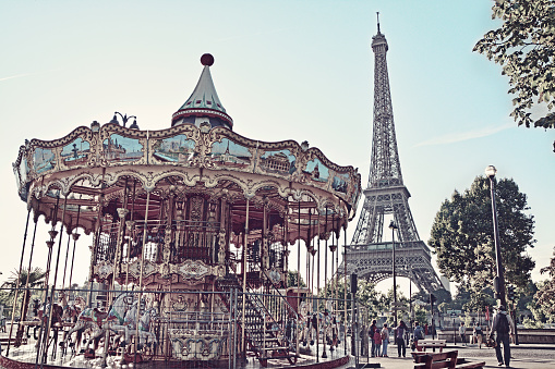 Eiffel Tower and vintage carousel in Paris, France. Retro style