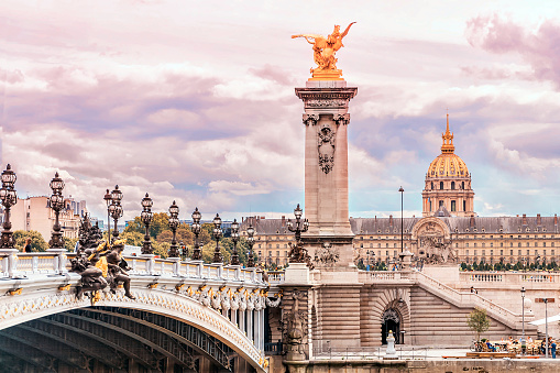Pont Alexandre III (Alexandre III bridge) and Les Invalides dome in Paris, France