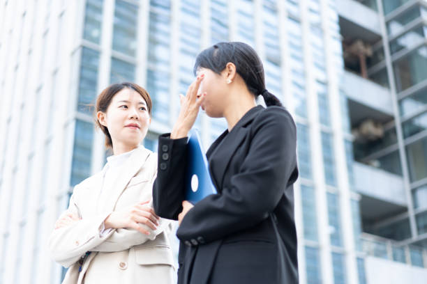 istock Two female white-collar workers communicate on the road 1471864185