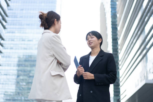 istock Two female white-collar workers communicate on the road 1471864915