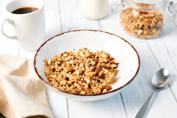 Granola with nuts and a cup of coffee for breakfast. Balanced diet for vegetarians or vegans.