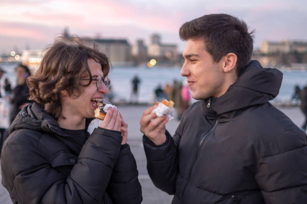 istock Handsome boys eating snack outdoors 1471865563