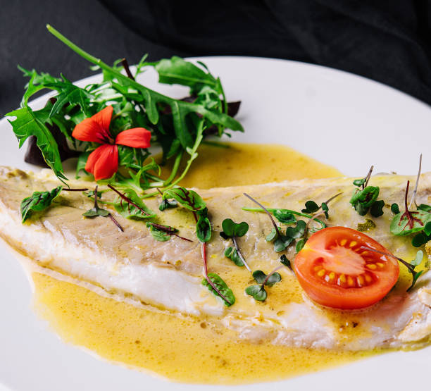 istock Fish fillet in white sauce on white plate 1471866711