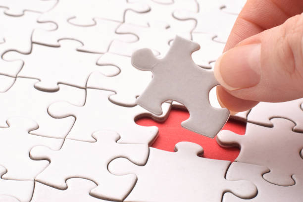 istock Jigsaw game. One white piece in hand and empty red space of true connection. 1471866838